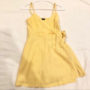 Yellow wrap romper with side knot